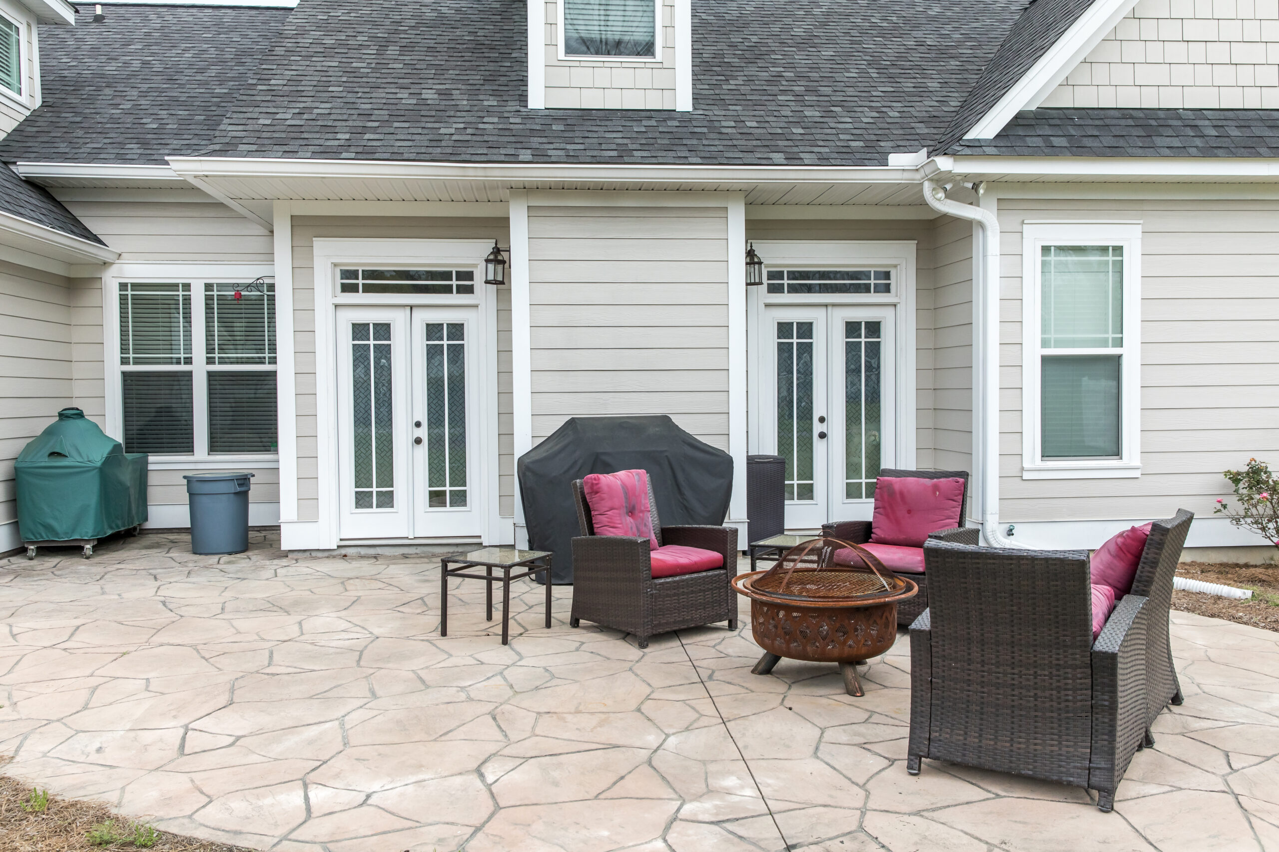 The back rear view of a new construction home with a covered up